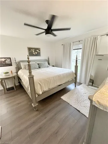 Bedroom with dark wood-type flooring and ceiling fan