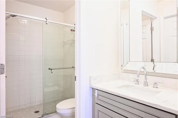 Bathroom with vanity and a shower stall
