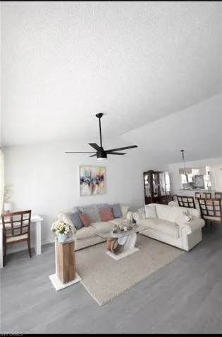 Living area with light wood-style floors and ceiling fan