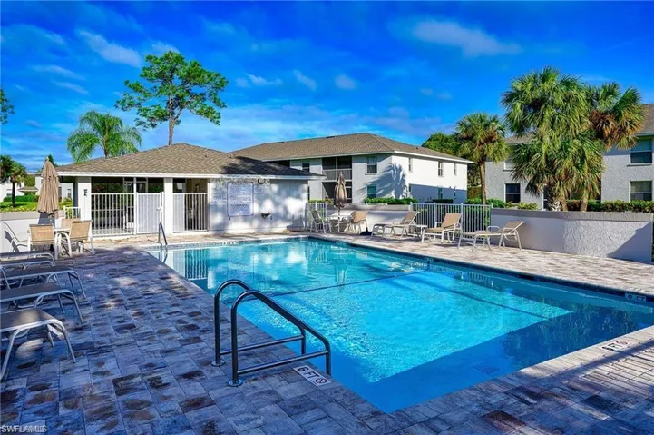 Community pool with a patio