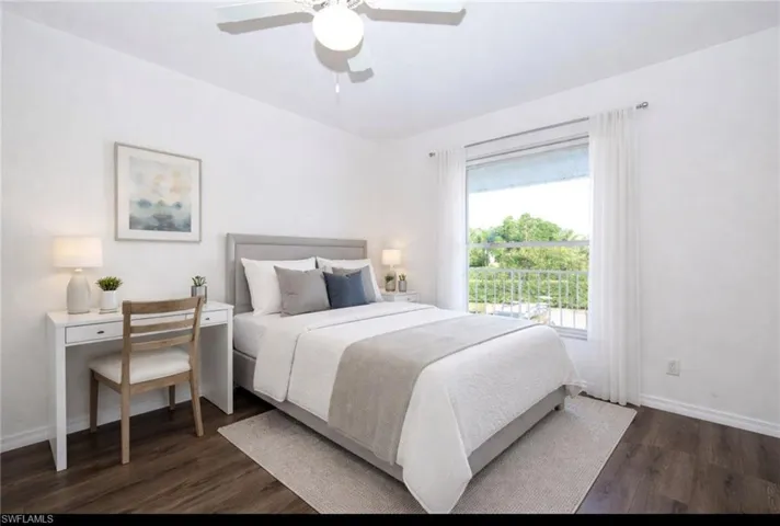 Bedroom with dark wood-style flooring and a ceiling fan