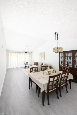 Dining room featuring wood finished floors and a chandelier