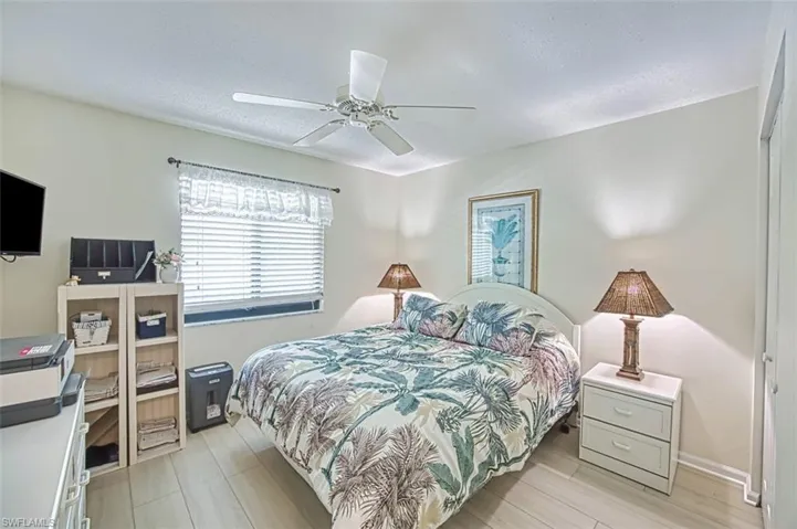 Bedroom with light hardwood / wood-style flooring, a closet, and ceiling fan
