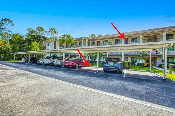 View of parking featuring a carport