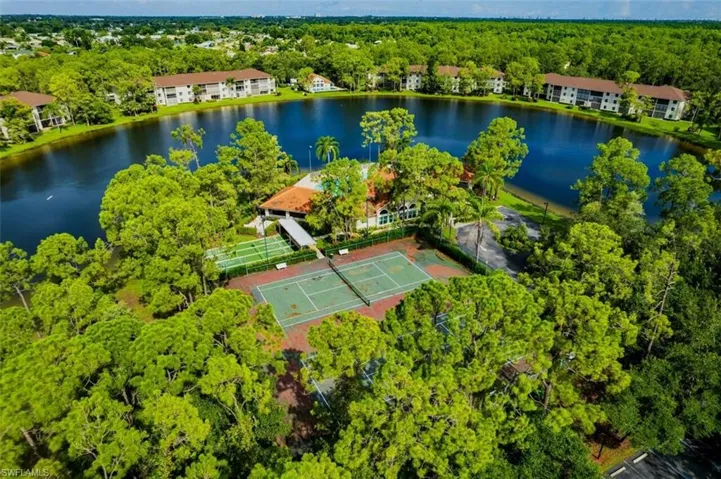 Birds eye view of property with a water view