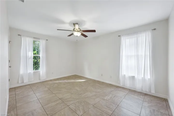 Large primary bedroom with tons of natural light