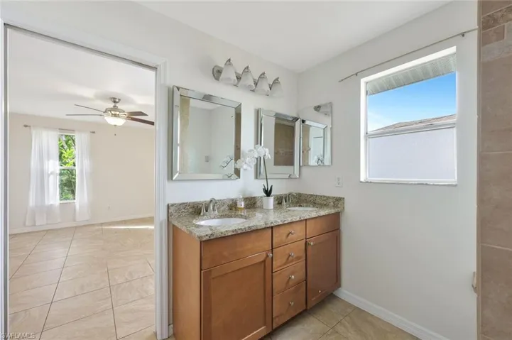 Primary Bathroom with double vanity, and natural light