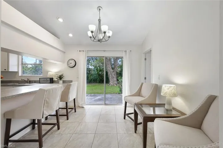 Dining area with large square-format tile throughout.