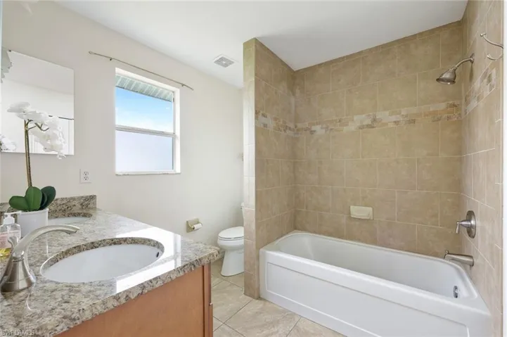 Primary bathroom with tub/shower and dual sinks