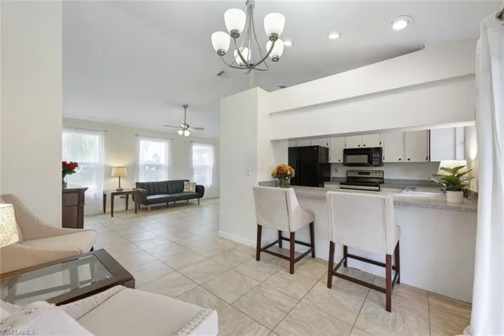 Kitchen features black appliances and white cabinetry, and presents an opportunity to personalize your space.