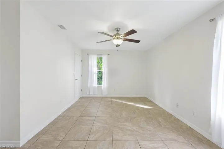 Large primary bedroom with tons of natural light