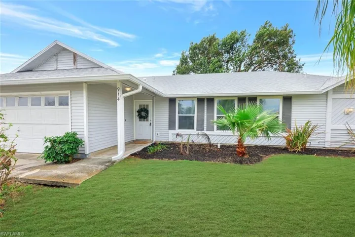 Front elevation of home with covered porch entryway.  Triple windows to main living area provide tons of natural light.