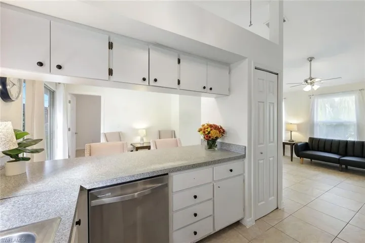 Kitchen features black appliances and white cabinetry, and presents an opportunity to personalize your space.