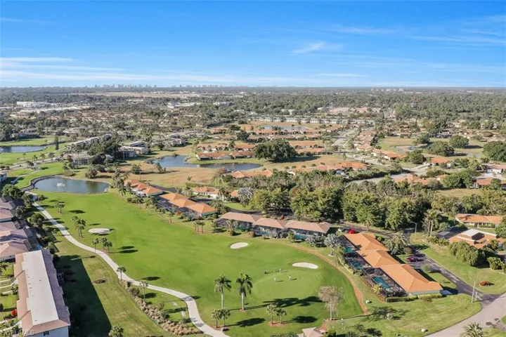 Birds eye view of property with a water view, a residential view, and golf course view