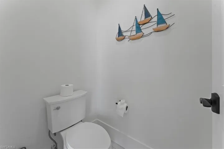 Bathroom featuring toilet and baseboards