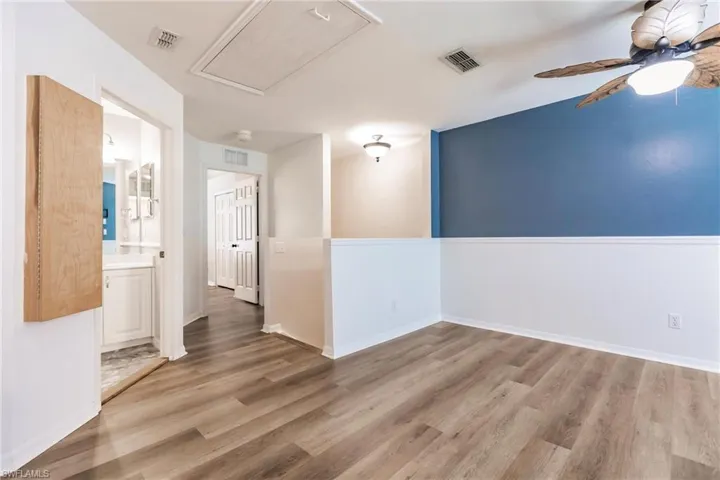 Unfurnished room with ceiling fan and light hardwood / wood-style floors