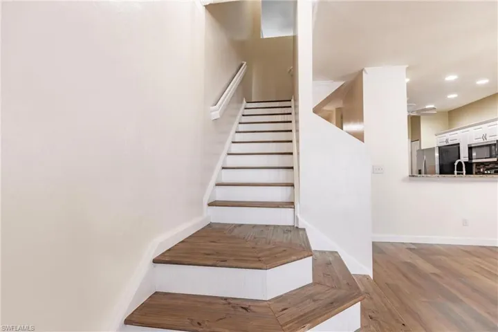 Stairway featuring wood-type flooring