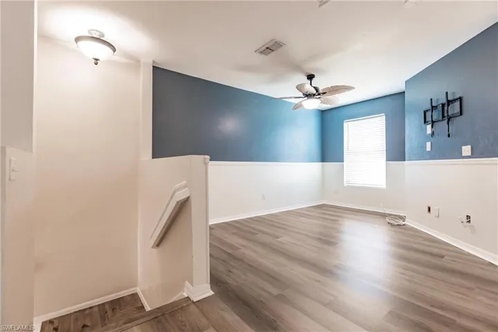 Unfurnished room featuring wood-type flooring and ceiling fan