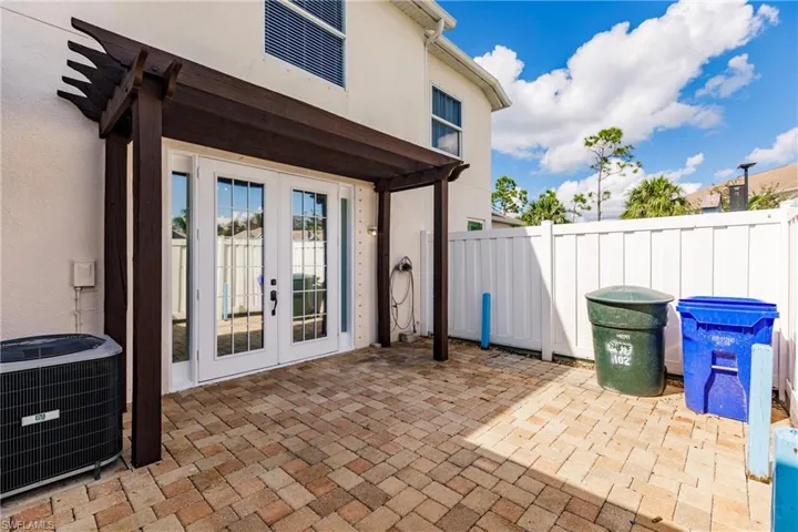 View of patio featuring french doors and cooling unit