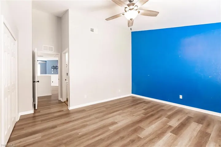 Empty room featuring wood-type flooring and ceiling fan