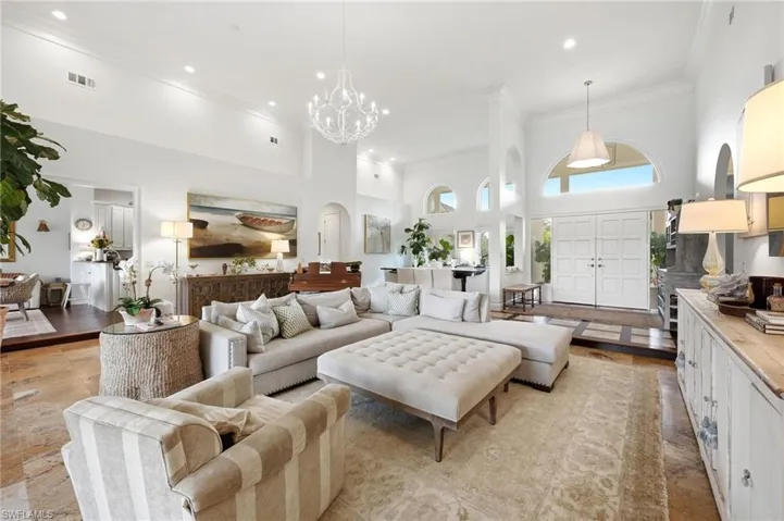 Vaulted ceilings, arched windows, grand double entry doors, recessed lighting, and tile flooring