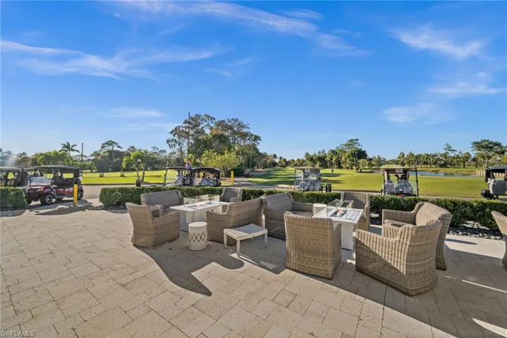View of patio / terrace featuring golf course view, a water view, and an outdoor living space with a fire pit