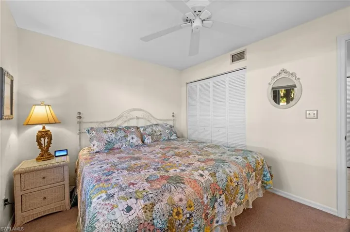Bedroom featuring carpet, a ceiling fan, and a closet