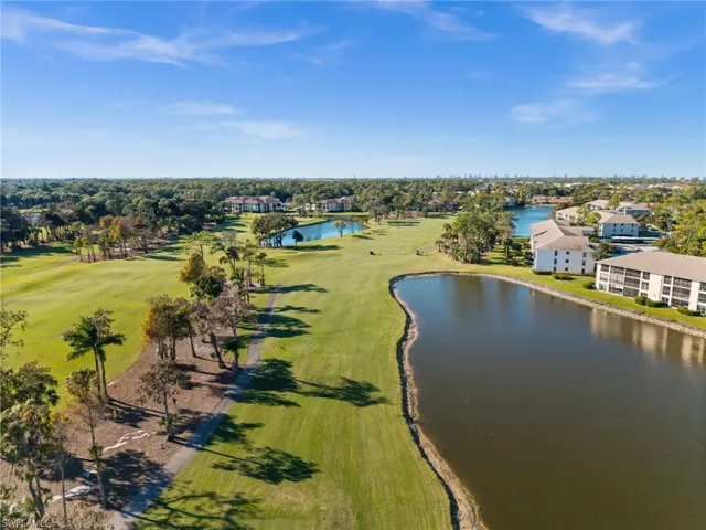 Drone / aerial view of a nearby body of water and a local golf course