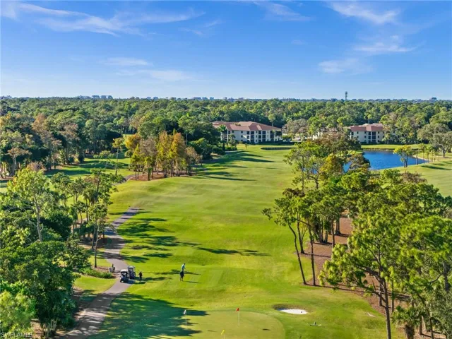 Drone / aerial view of a golf club and a tree filled landscape