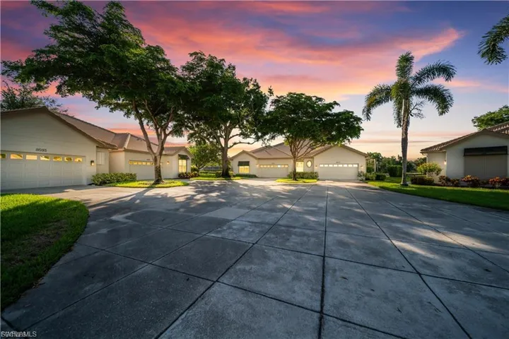 Ranch-style house featuring driveway, an attached garage, and a residential view