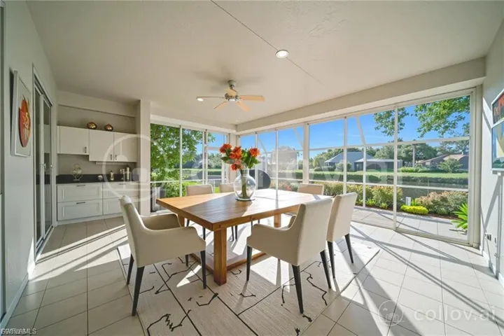 Sunroom with tile patterned flooring and a residential view