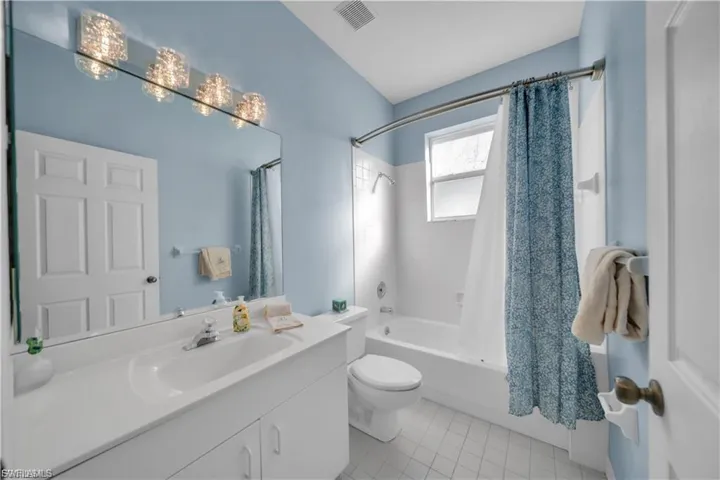 Full bathroom featuring vanity, shower / bath combo, and light tile patterned floors
