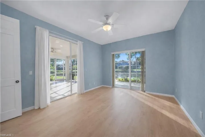 virtually staged Master bedroom featuring light wood finished floors and a ceiling fan