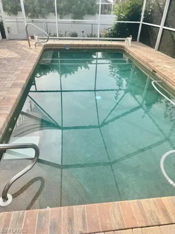 View of swimming pool with a patio (with pavers) and a lanai