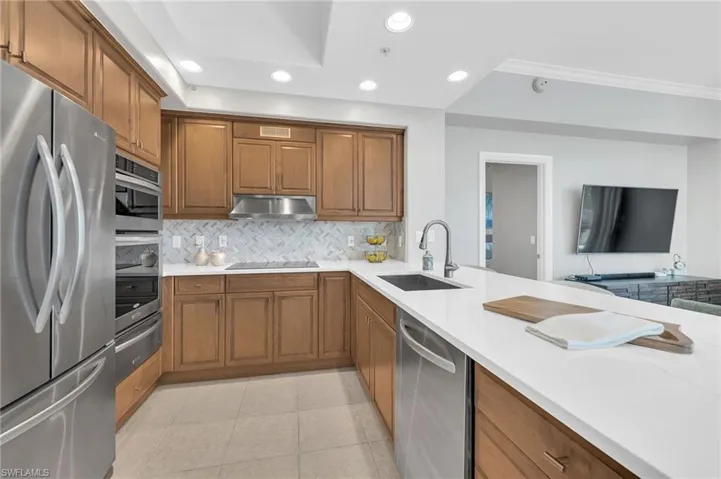 Kitchen featuring warm-toned cabinetry and stainless steel appliances