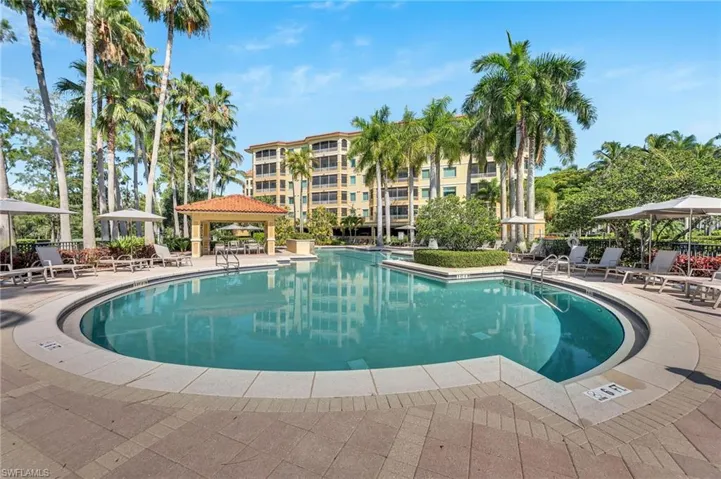 Expansive resort-style pool featuring a curved design and integrated steps