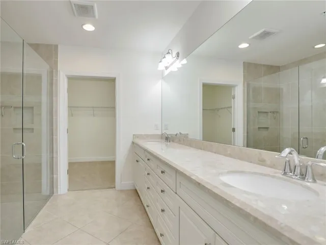 Primary Bathroom With  Walk In Tiled Shower With Niche, Glass Shower Enclosure, Long Quartz Vanity & Large Walk In Closet
