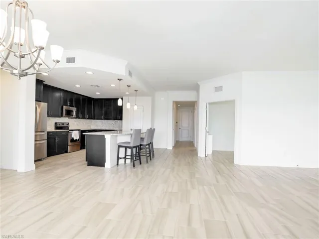 Great Room With Door To The Den & Hallway To Guest Area & Laundry