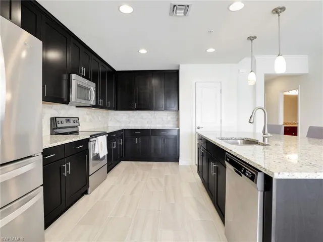 Kitchen With Granite Counters, Stainless Steel Whirlpool Appliances, Tile Backsplash & Pantry