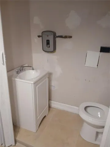 Half bathroom with vanity and light tile patterned floors