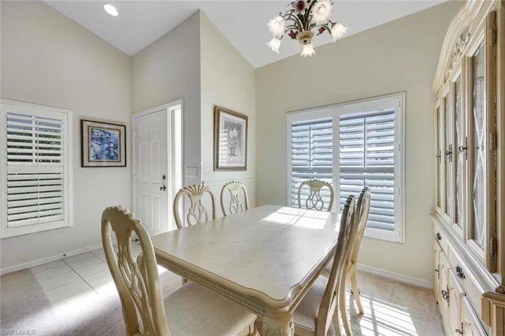 Dining room featuring a chandelier, light carpet,