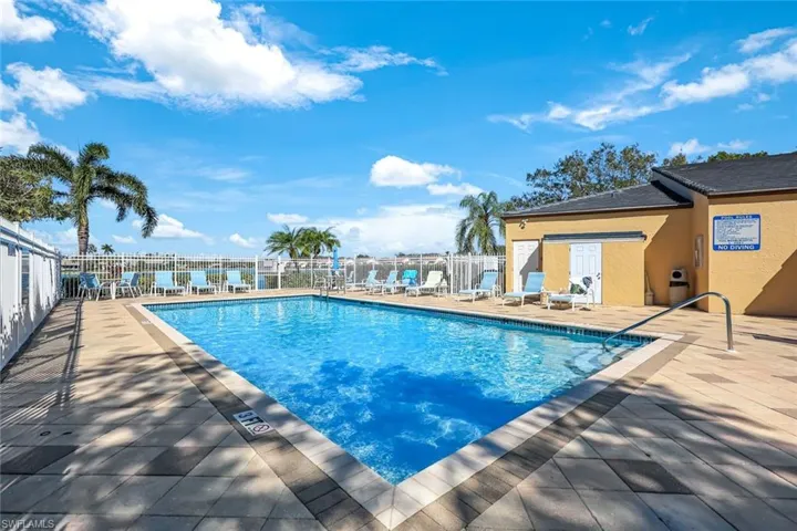 2nd Community pool with a patio area and fence
