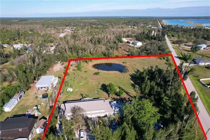 Birds eye view of property with a water view