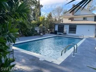 View of pool with an outbuilding and a patio