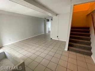 Basement featuring light tile patterned flooring