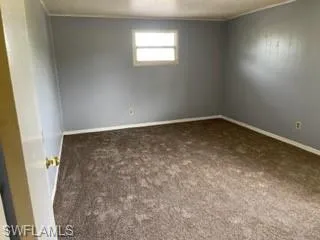 Spare room featuring carpet floors and a textured ceiling