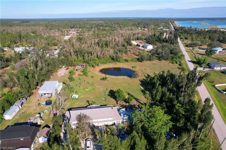 Birds eye view of property with a water view