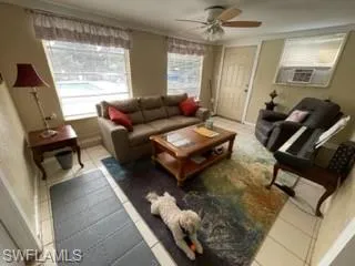 Tiled living room with cooling unit and ceiling fan