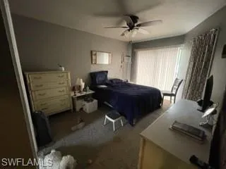 Carpeted bedroom with ceiling fan