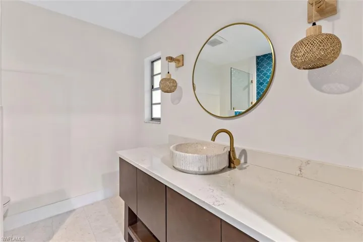 Bathroom with vanity, tile patterned flooring, and toilet